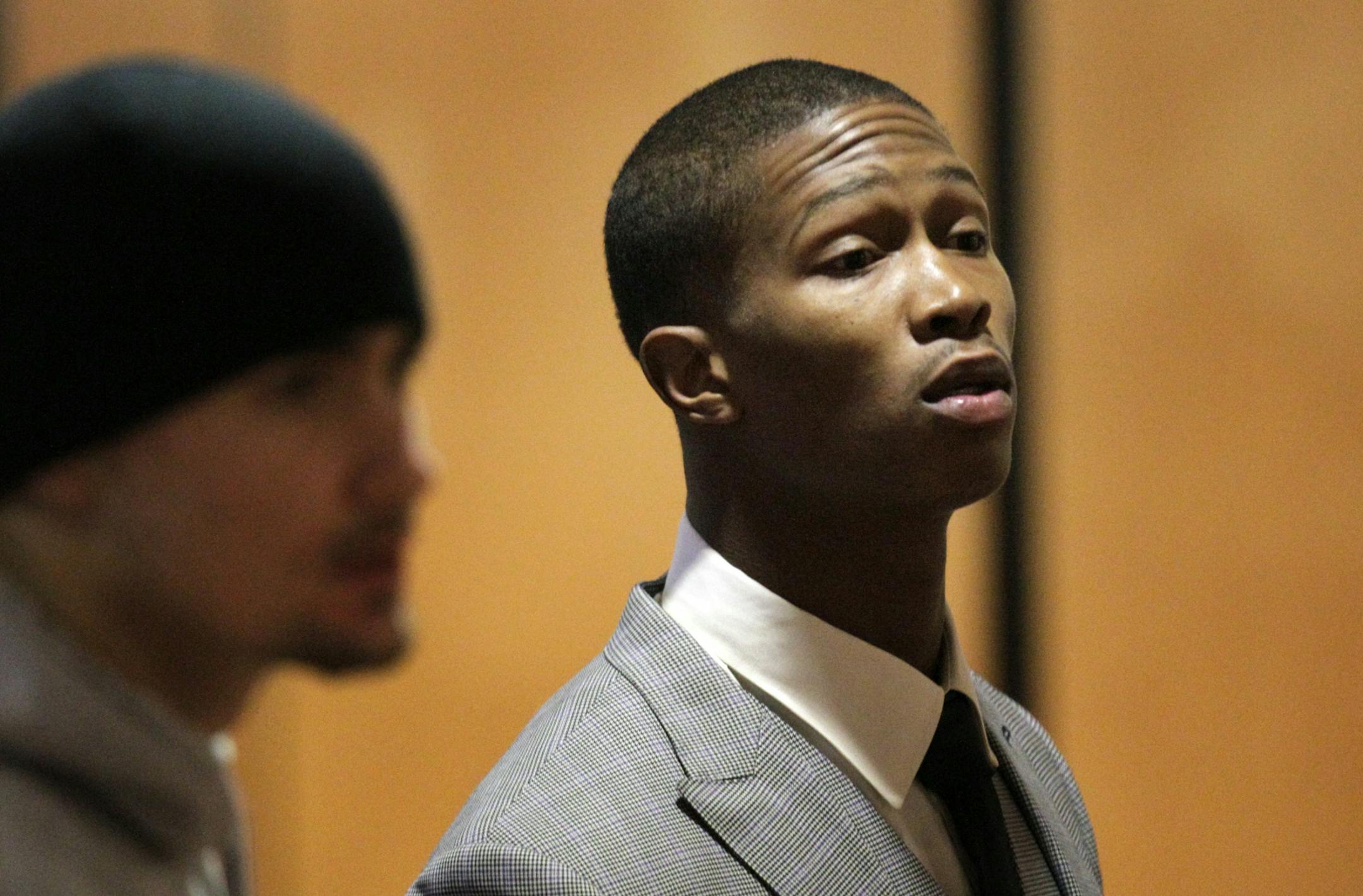 With fresh closely shaven hair cut, Vikings player Chris Cook (right) made a court appearance Tuesday morning to answer to felony domestic assault charges for allegedly strangling his girlfriend.