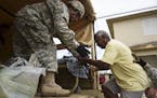 National Guard personnel evacuate Toa Ville resident Luis Alberto Martinez after the passing of Hurricane Maria, in Toa Baja, Puerto Rico, Friday, Sep