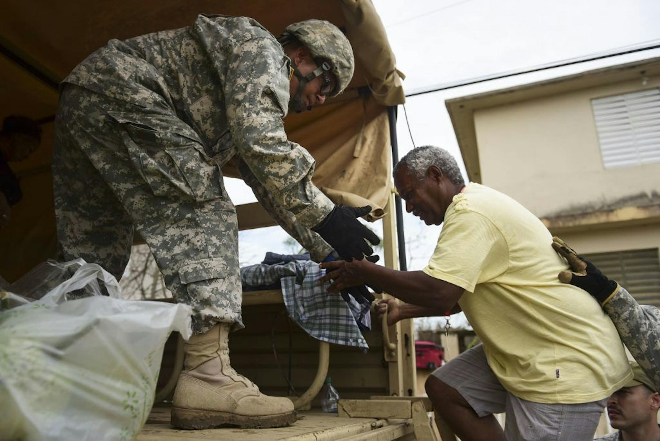 National Guard personnel evacuate Toa Ville resident Luis Alberto Martinez after the passing of Hurricane Maria, in Toa Baja, Puerto Rico, Friday, September 22, 2017. Because of the heavy rains brought by Maria, thousands of people were evacuated from Toa Baja after the municipal government opened the gates of the Rio La Plata Dam.
