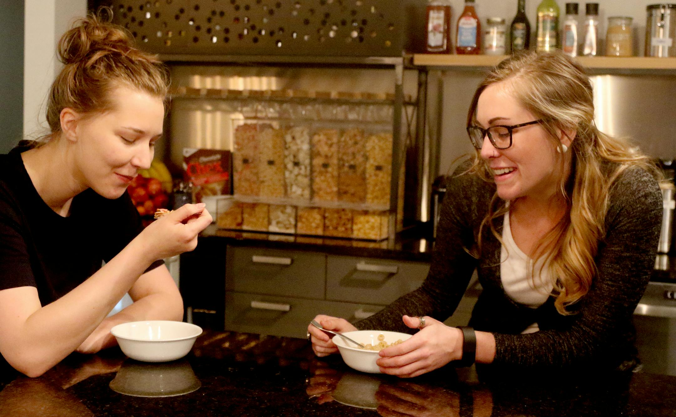 Jaks Pierre, right, is a 25-year-old communication specialist and U of M grad who works at marketing agency Six Speed. She started eating cereal again after her employer installed a cereal bar. Pierre was seen at Six Speed eating cheerios with fellow employee Laura Hansel Thursday, April 21, 2016, in St. Louis Park, MN. "I don't feel like it's (breakfast cereal) going away," Pierre said. "A lot of my friends are eating it."](DAVID JOLES/STARTRIBUNE)djoles@startribune.com Cereal is still king of