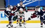 Minnesota Wild right wing Gerald Mayhew, front center, fights for control of the puck with, from left, Colorado Avalanche defensemen Cale Makar and Bo