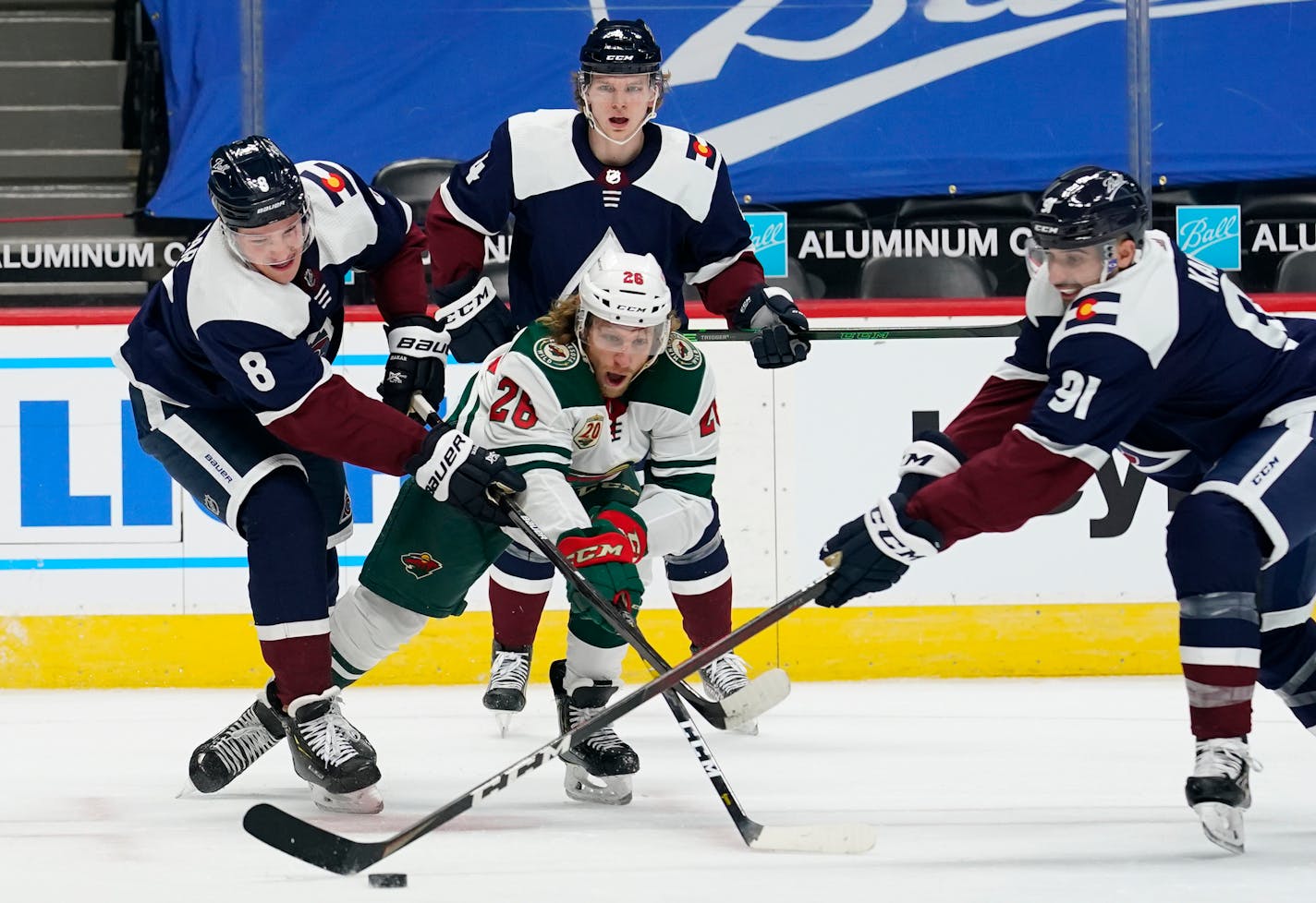 Minnesota Wild right wing Gerald Mayhew, front center, fights for control of the puck with, from left, Colorado Avalanche defensemen Cale Makar and Bowen Byram and center Nazem Kadri in the second period