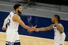 Minnesota Timberwolves center Karl-Anthony Towns celebrates with Minnesota Timberwolves guard D'Angelo Russell (0) against the Chicago Bulls during an