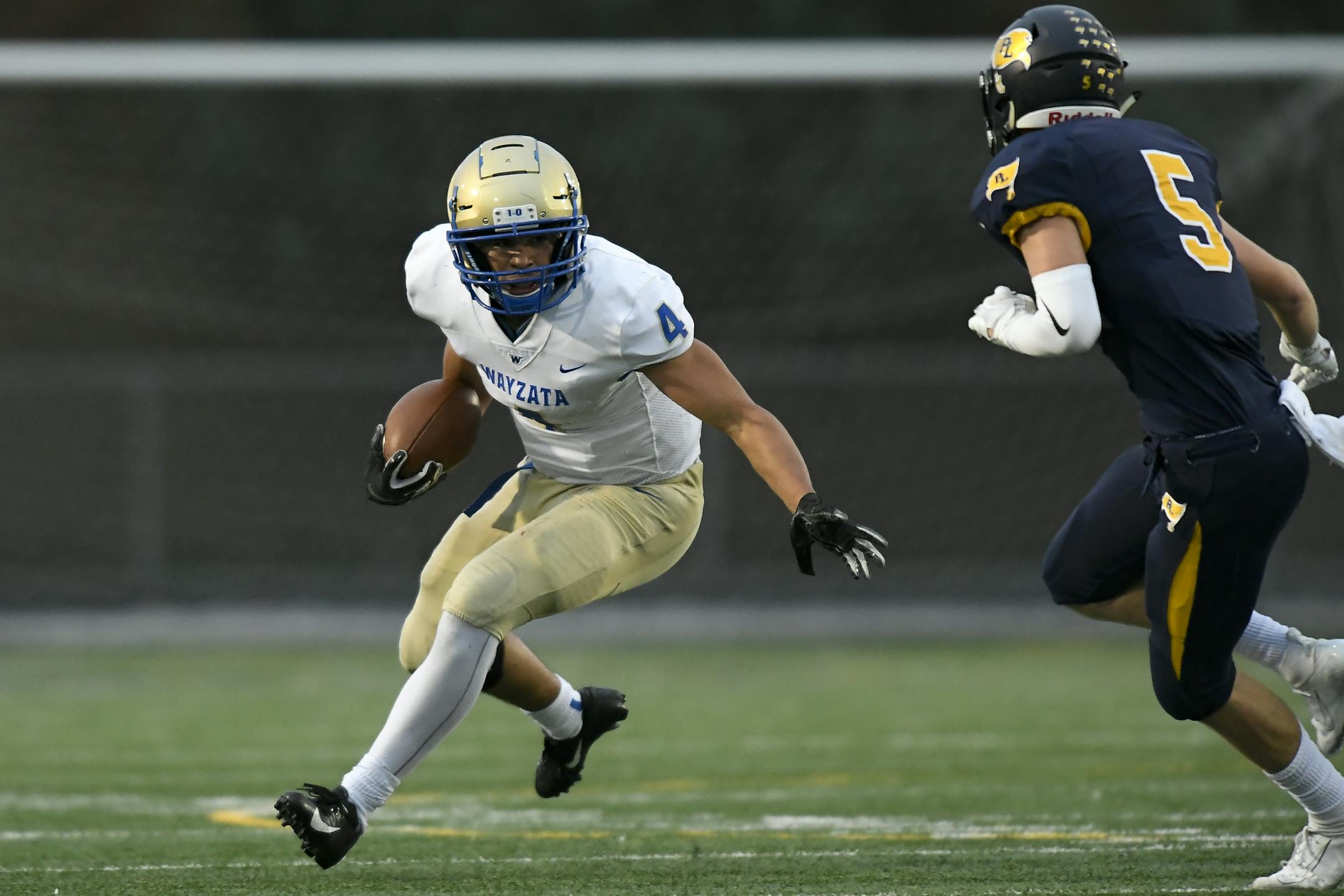 Wayzata running back Christian Vasser (4) ran the ball for a first down against Prior Lake defensive back Nick Larson (5) in the first half of the game on Sept. 13 at Prior Lake. Photo: Aaron Lavinsky • aaron.lavinsky@startribune.com