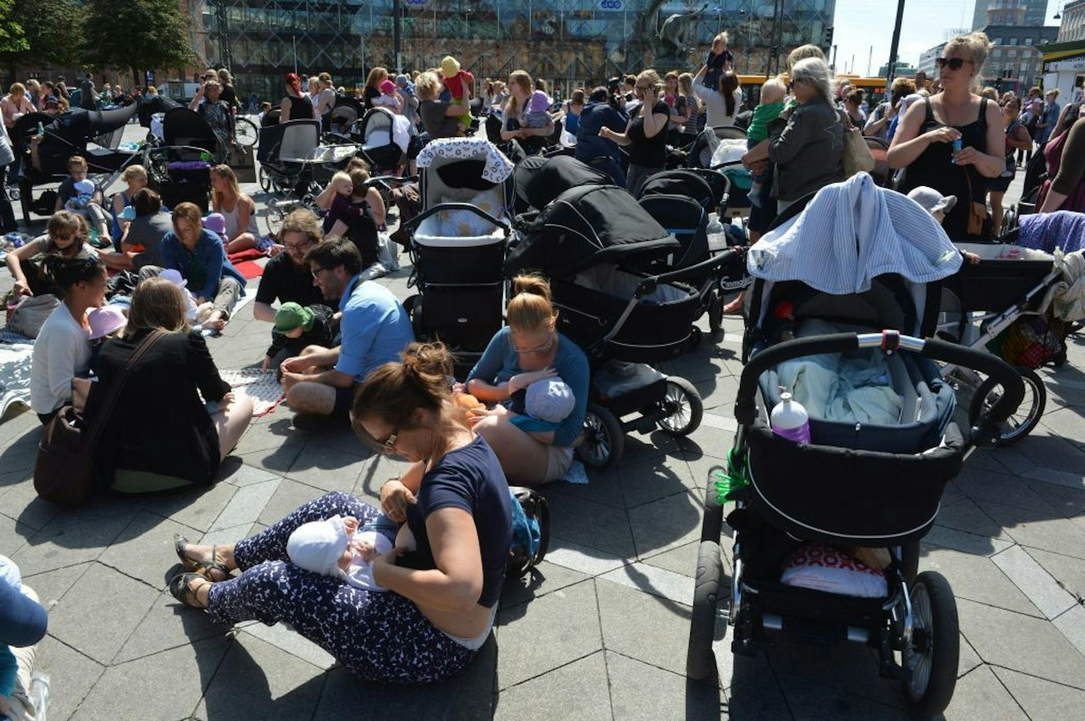 Hundreds of women feed their babies outside City Hall Square in Copenhagen, Monday June 17, 2013, in a demonstration to promote public breastfeeding after customers at a cafe told a woman suckling her baby that it was disgusting.