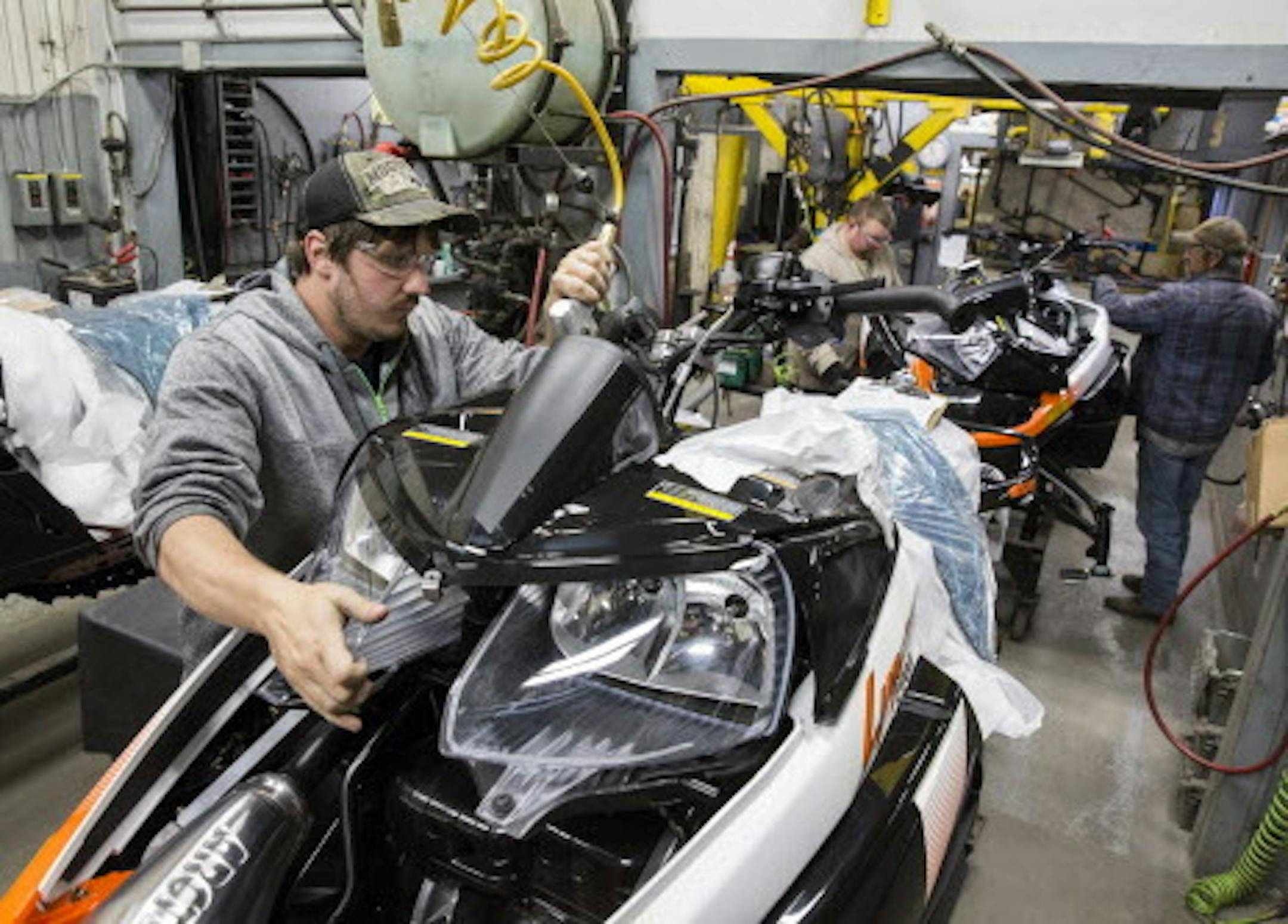 A worker puts the finishing touches on a 2016 Lynx 2000 snowmobile before it is boxed up for shipping at the Arctic Cat factory in Thief River Falls on Wednesday, September 30, 2015. ] LEILA NAVIDI leila.navidi@startribune.com / BACKGROUND INFORMATION: Arctic Cat management did not allow the photographer to get any names of the workers.