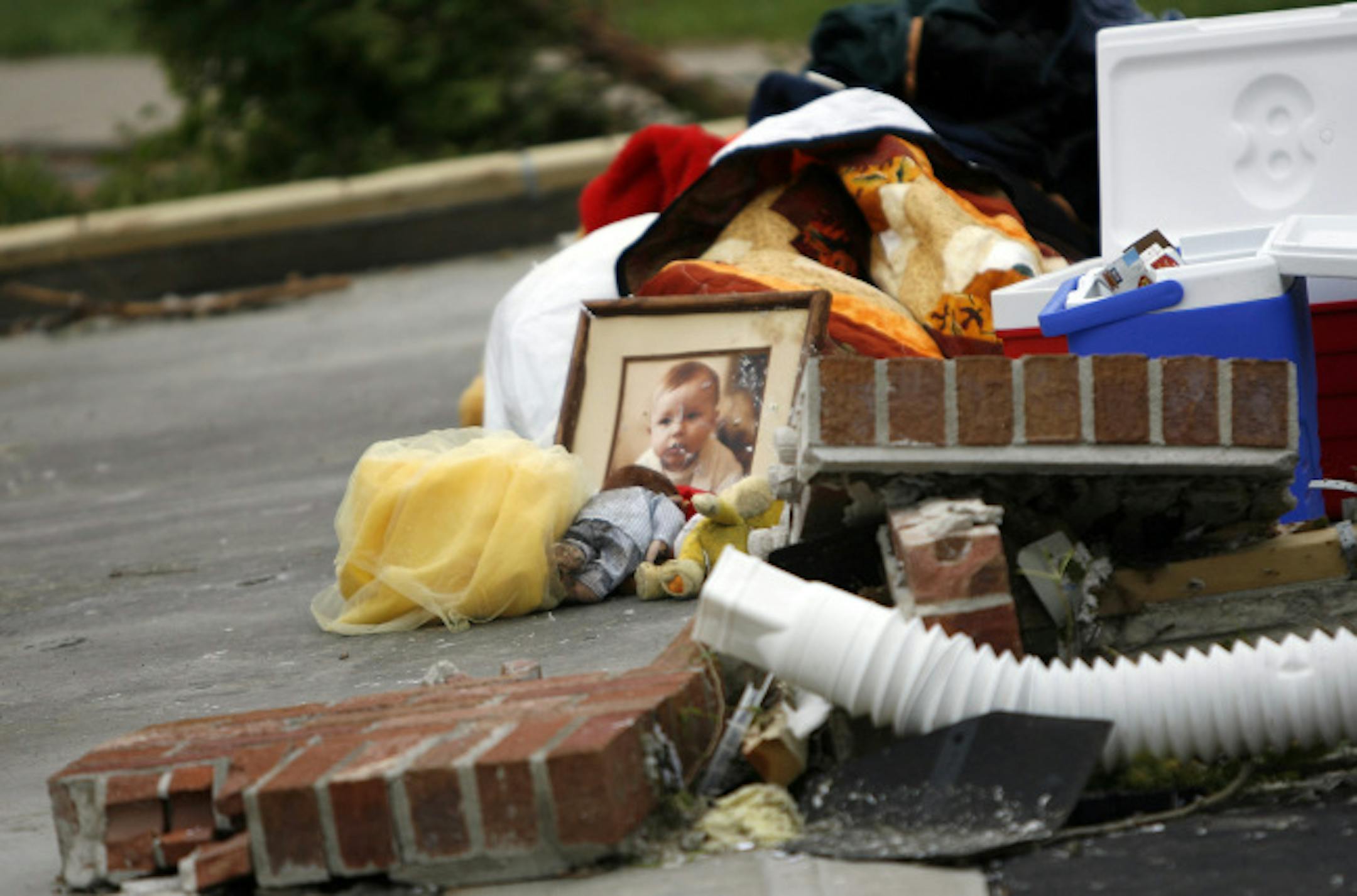 Friends, family and strangers collected valuables and put them in the driveway at the Prindle home in Hugo. Nathaniel Prindle, 2, died after his home was blown into a nearby pond.