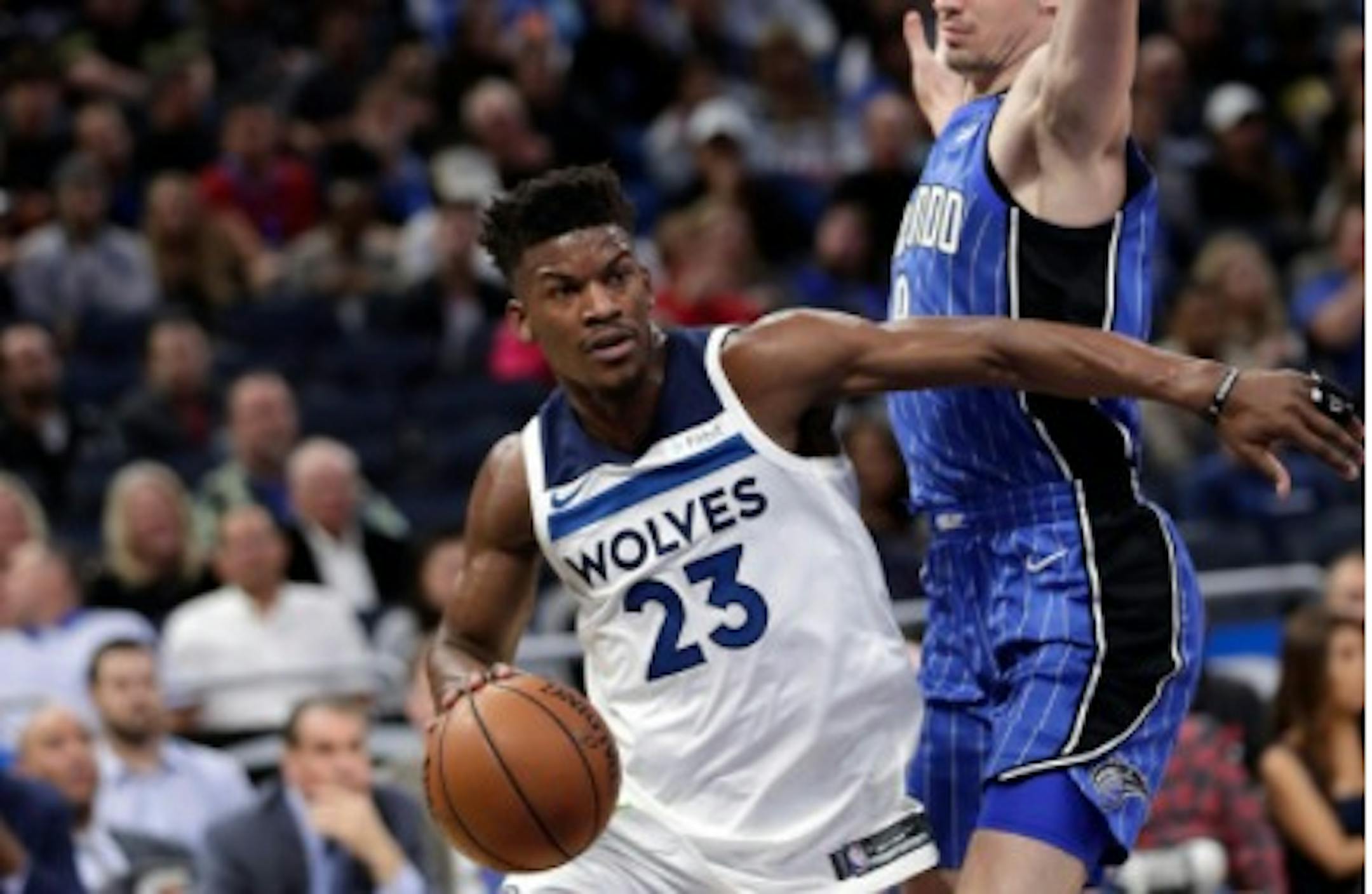 Wolves star Jimmy Butler (23) drives around Orlando Magic's Mario Hezonja during the first half of Tuesday's game.