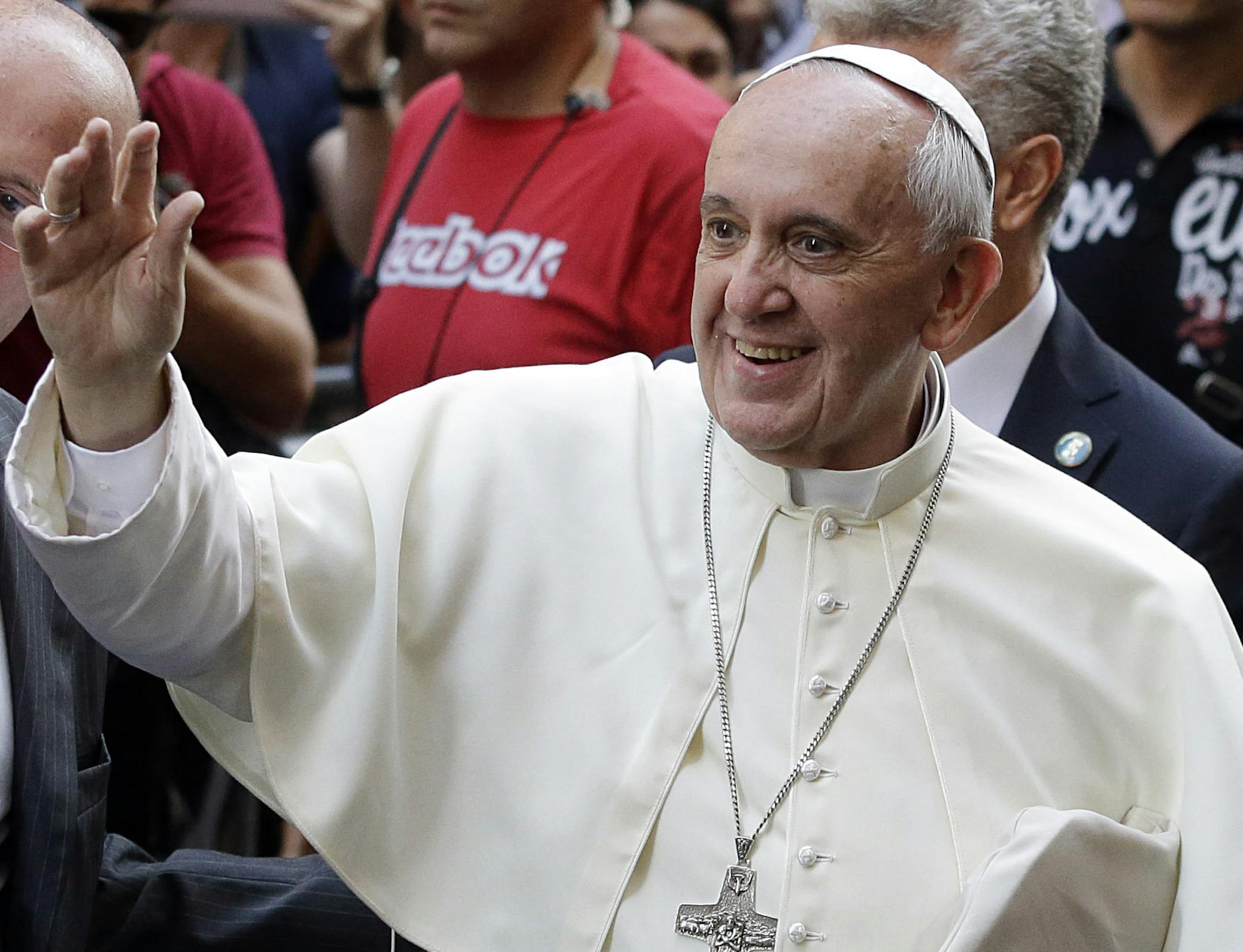 Pope Francis greets the faithful as he arrives for a Mass at the St. Agostino church in downtown Rome in August.