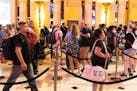 Hotel guests wait in line as they check in at Luxor hotel casino in Las Vegas.