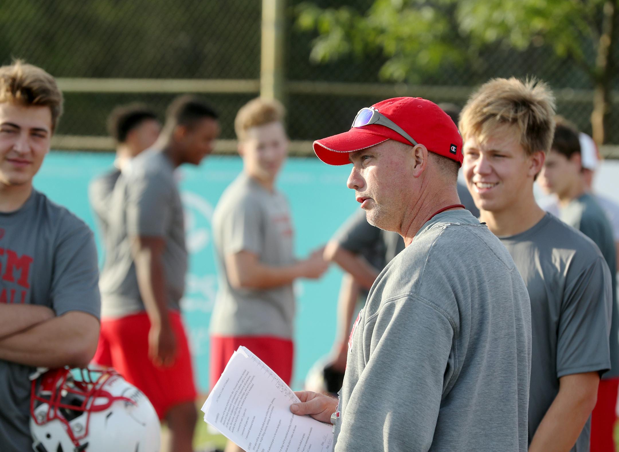 Benilde-St. Margaret's football is kicking off a new season as the defending Class 4A state champions. Here, Benilde-St. Margaret's head coach Jon Hanks talks with players before the start of the second day of practice Tuesday, Aug. 15, 2016, in St. Louis Park, MN.] DAVID JOLES ï david.joles@startribune.com Benilde-St. Margaret's football is kicking off a new season as the defending Class 4A state champions