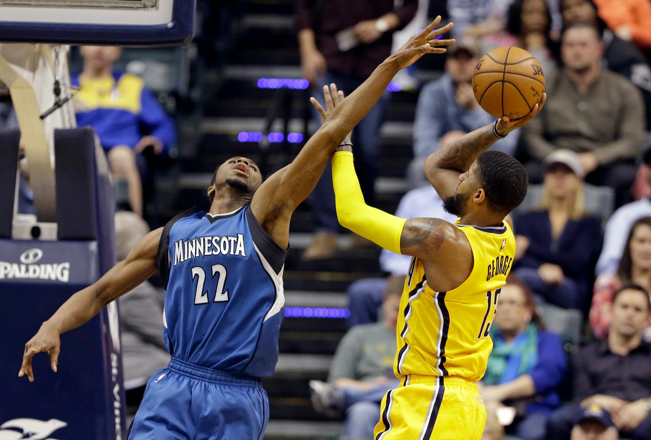 Indiana Pacers forward Paul George (13) shoots over Minnesota Timberwolves forward Andrew Wiggins (22) during the first half of an NBA basketball game in Indianapolis, Tuesday, March 28, 2017.
