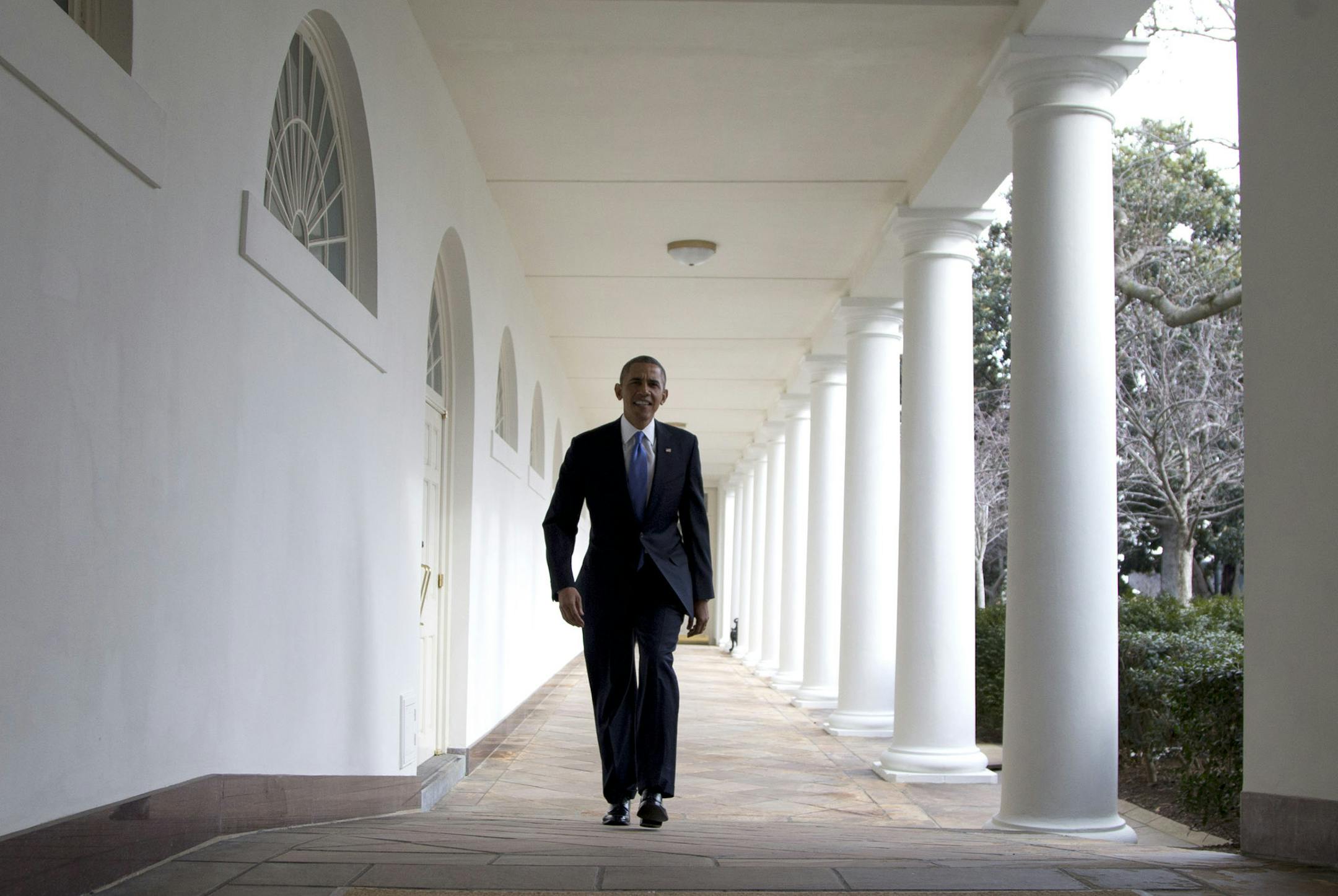 President Barack Obama walks along the Colonnade at the White House, Tuesday, Jan. 28, 2014, in Washington, hours before delivering the State of the Union Address before a joint session of congress. (AP Photo/Carolyn Kaster) ORG XMIT: MIN2014012820042692