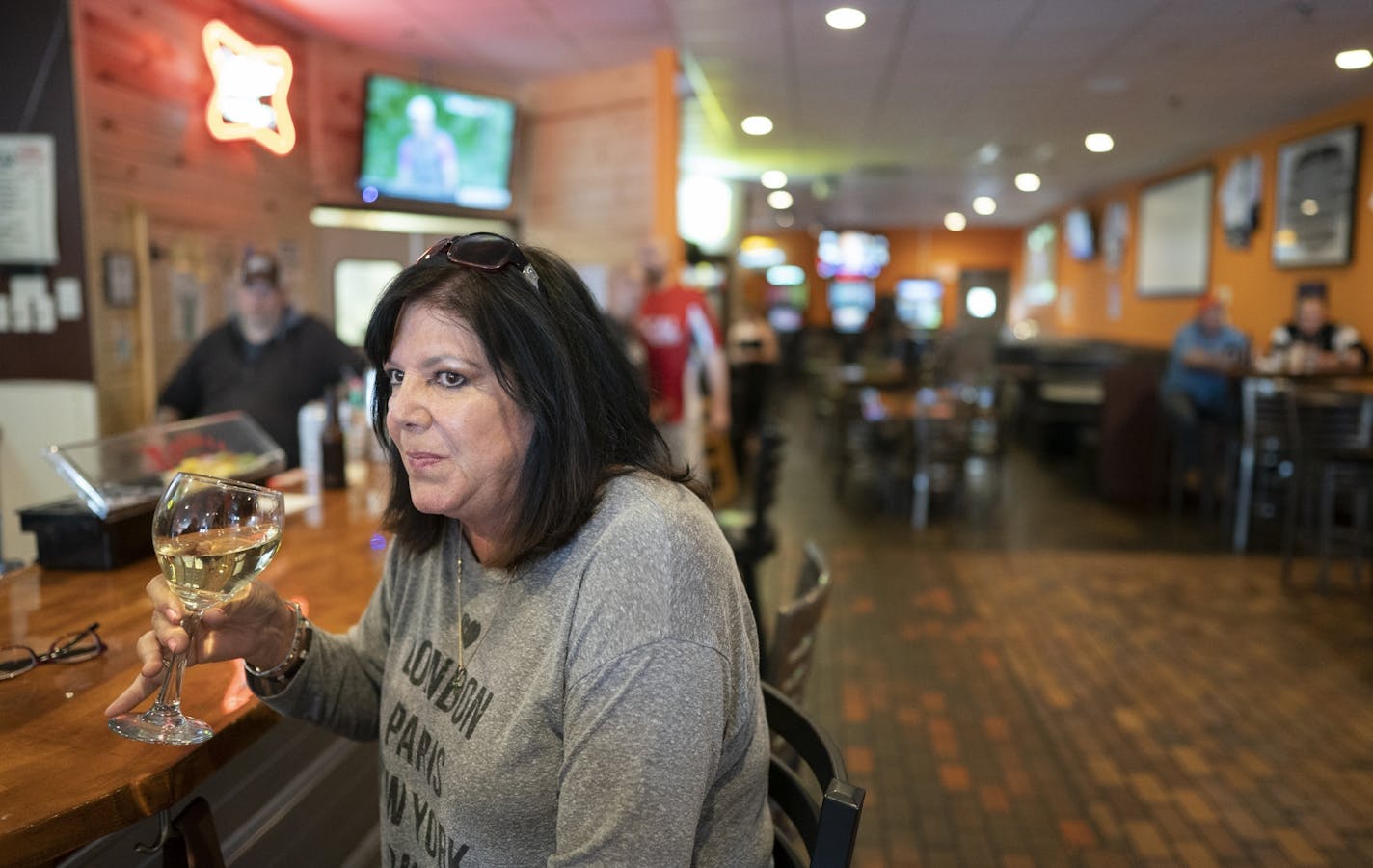 Sherrie Carlson of Hudson enjoyed a glass of wine at Jonesy's Local Bar on the first day of the bar reopening in Hudson .