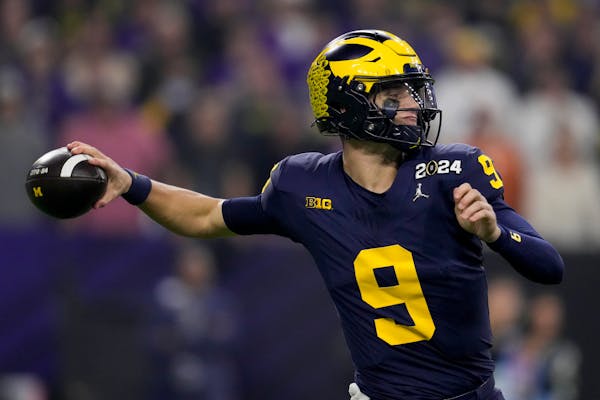 Michigan quarterback J.J. McCarthy passes against Washington during the first half of the Wolverines' NCAA championship victory.
