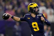 Michigan quarterback J.J. McCarthy passes against Washington during the first half of the NCAA national championship game in January. McCarthy got a v