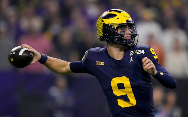 Michigan quarterback J.J. McCarthy passes against Washington during the first half of the Wolverines' NCAA championship victory.