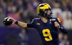 Michigan quarterback J.J. McCarthy passes against Washington during the first half of the NCAA national championship game in January. McCarthy got a v