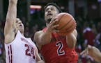 Maryland's Melo Trimble (2) shoots against Wisconsin's Bronson Koenig (24) during the first half of an NCAA college basketball game Sunday, Feb. 19, 2