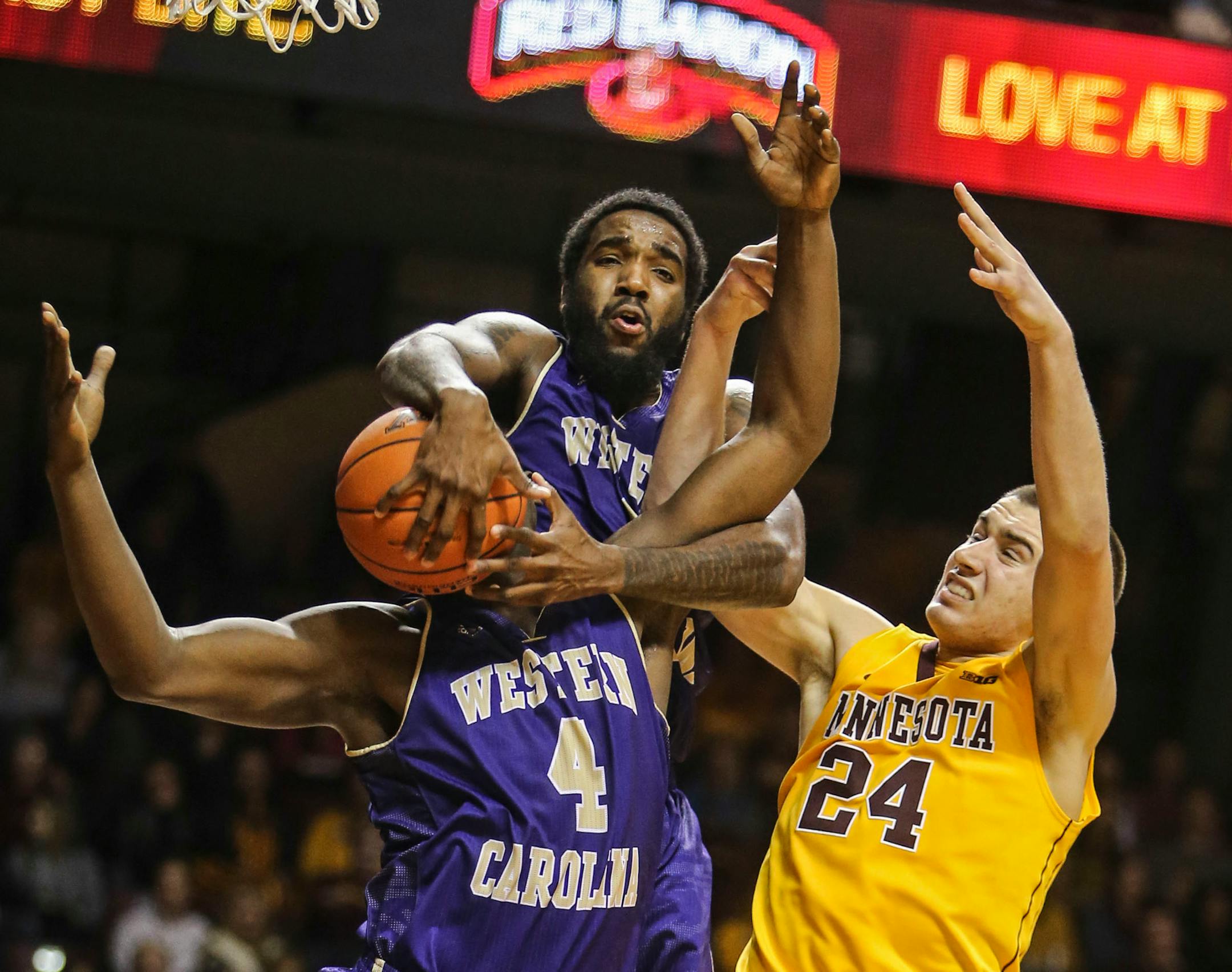 The University of Minnesota's Joey King (24) and Western Carolina Kenneth Hall, top, appear to be rebounding the basketball and the head of Western Carolina's Torrion Brummitt (4) during the second half Friday Dec. 5, 2014, at Williams Arena on the University of Minnesota campus in Minneapolis, MN. Minnesota beat Western Carolin 84-64.](DAVID JOLES/STARTRIBUNE)djoles@startribune.com U of M men's hoops versus Western Carolina