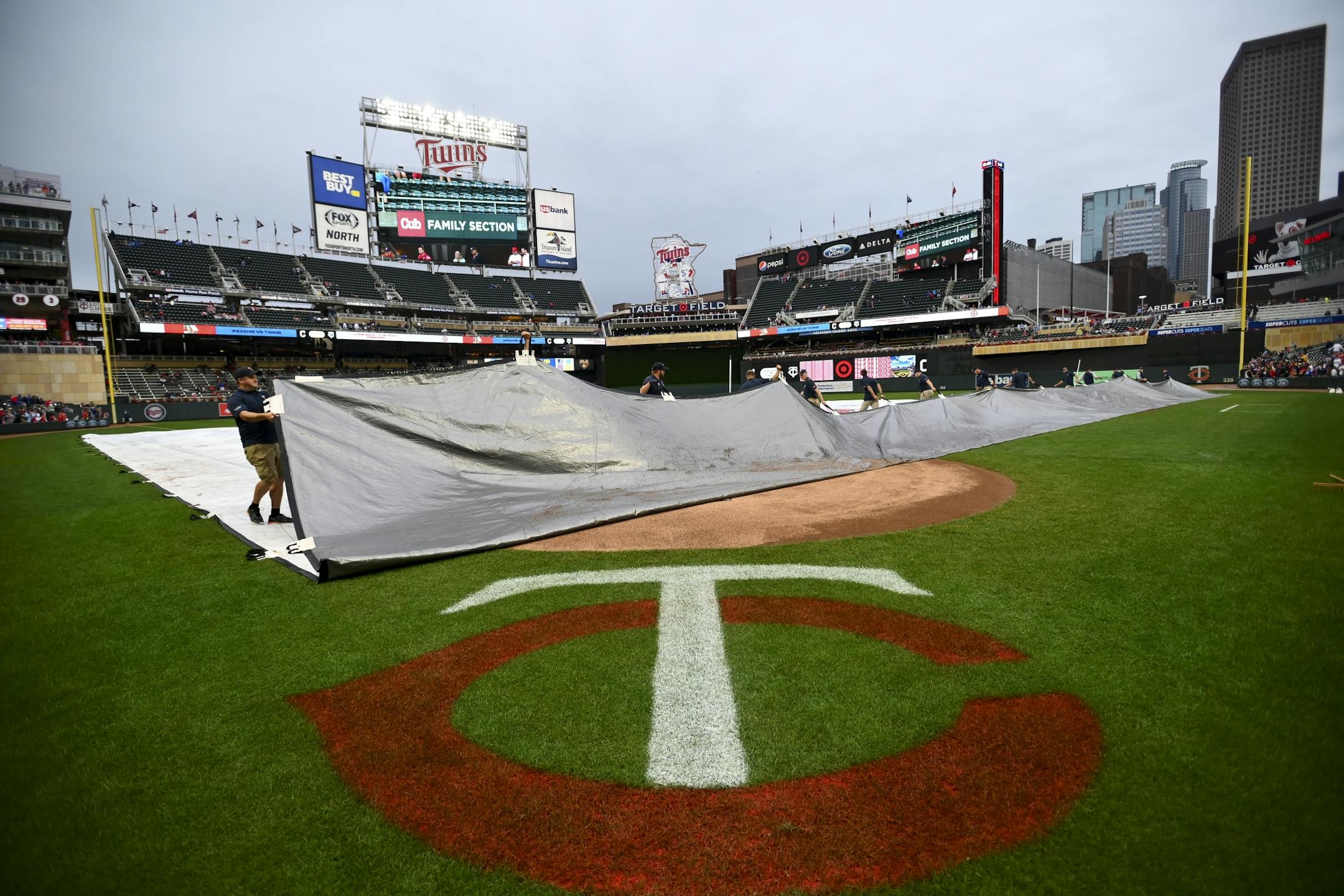 The Twins grounds crew moved the tarp during Saturday night's rain delay at Target Field.