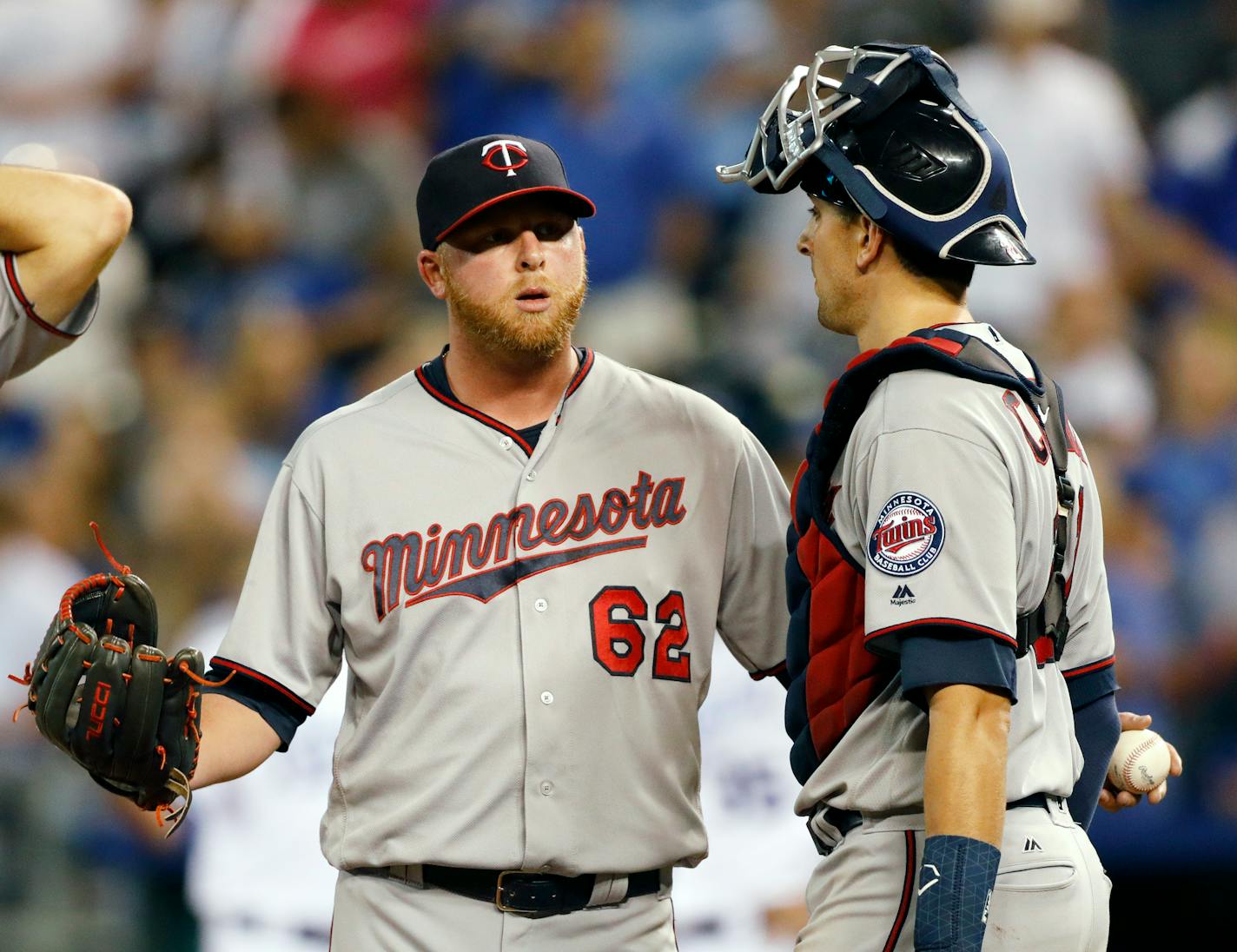 Minnesota Twins relief pitcher Buddy Boshers (62) talks with catcher Jason Castro following a single by Kansas City Royals' Eric Hosmer that scored the go-ahead run during the eighth inning at Kauffman Stadium in Kansas City, Mo., Saturday Sept. 9, 2017. The Royals won 5-2. (AP Photo/Colin E. Braley)