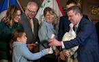 Lt. Gov. Peggy Flanagan's daughter Siobhan Hellendrung presented Paul Kvistad, president of the Minnesota Turkey Growers Association, with a coloring 