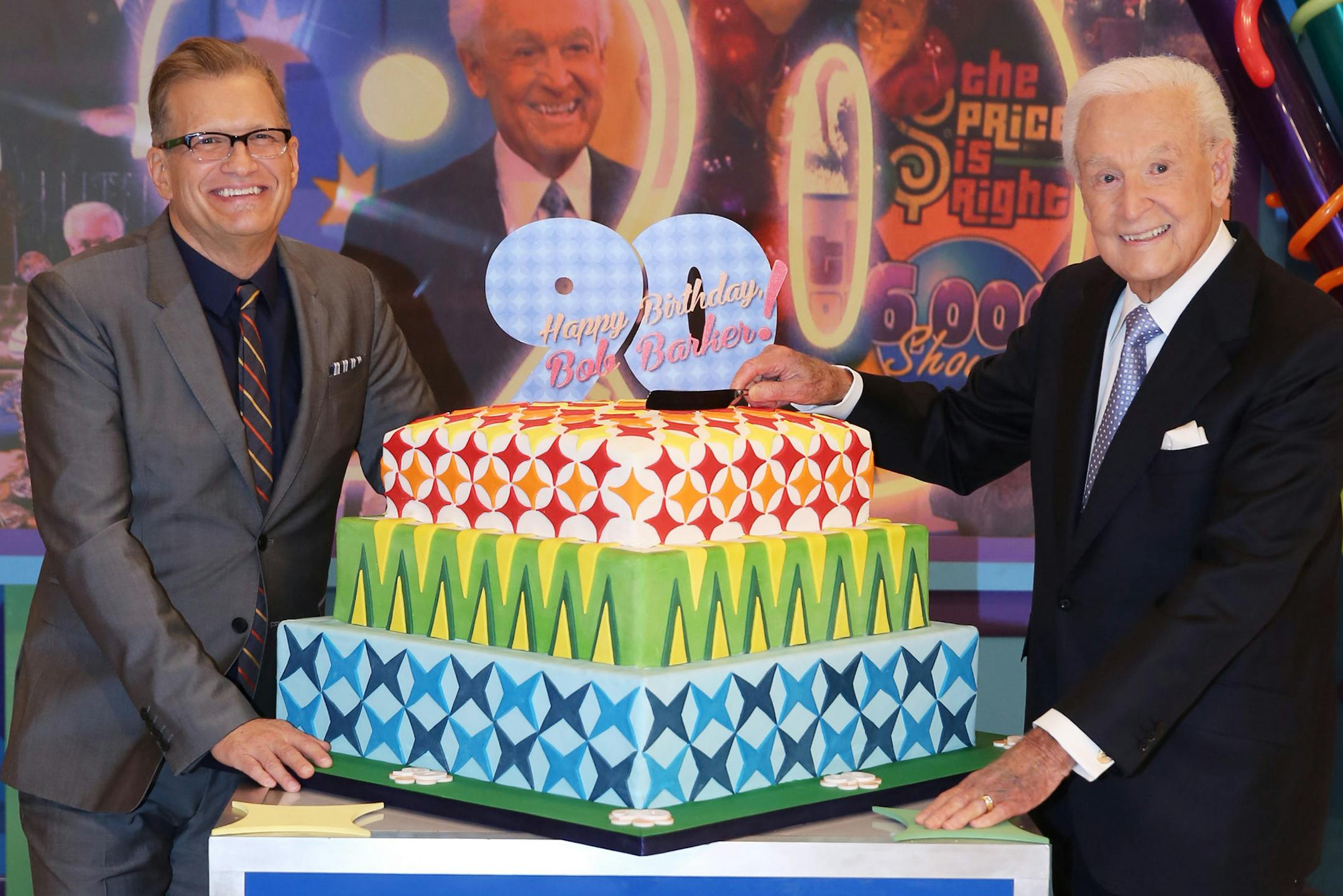 RETRANSMISSION TO CORRECT BOB BARKER, RIGHT AND DREW CAREY LEFT - Bob Barker, right, and Drew Carey pose for a photo on the set of "The Price is Right" after a special appearance that will celebrate Barker's 90th birthday at CBS Studios, on Tuesday, Nov. 5, 2013, in Los Angeles. (Photo by Matt Sayles/Invision/AP)