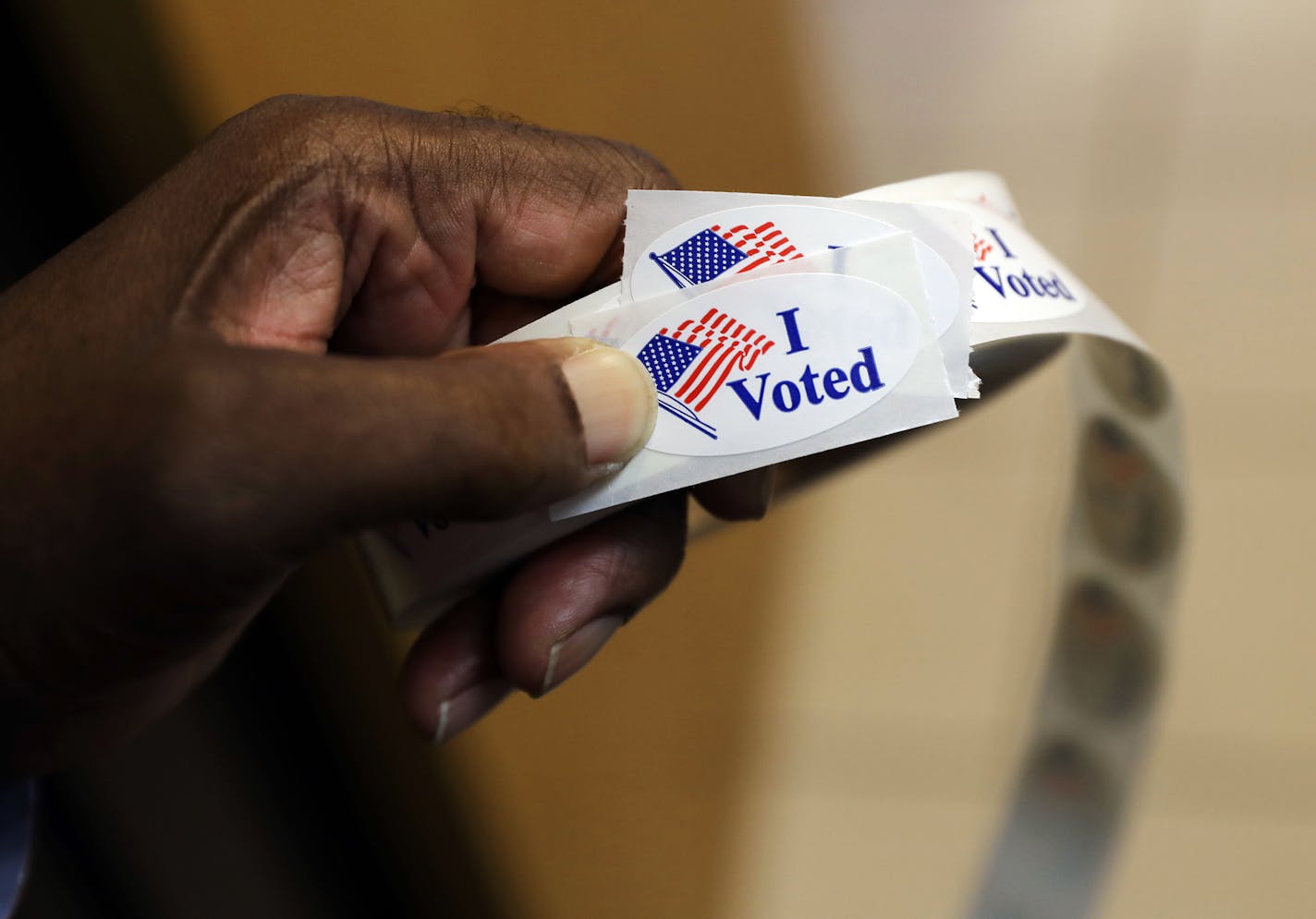 A volunteer prepares to hand out stickers to voters at an early polling station in Towson, Md., Tuesday, Nov. 1, 2016. In all, more than 45 million Americans are expected to vote before Election Day &#x2014; or as much as 40 percent of all votes cast. (AP Photo/Patrick Semansky)