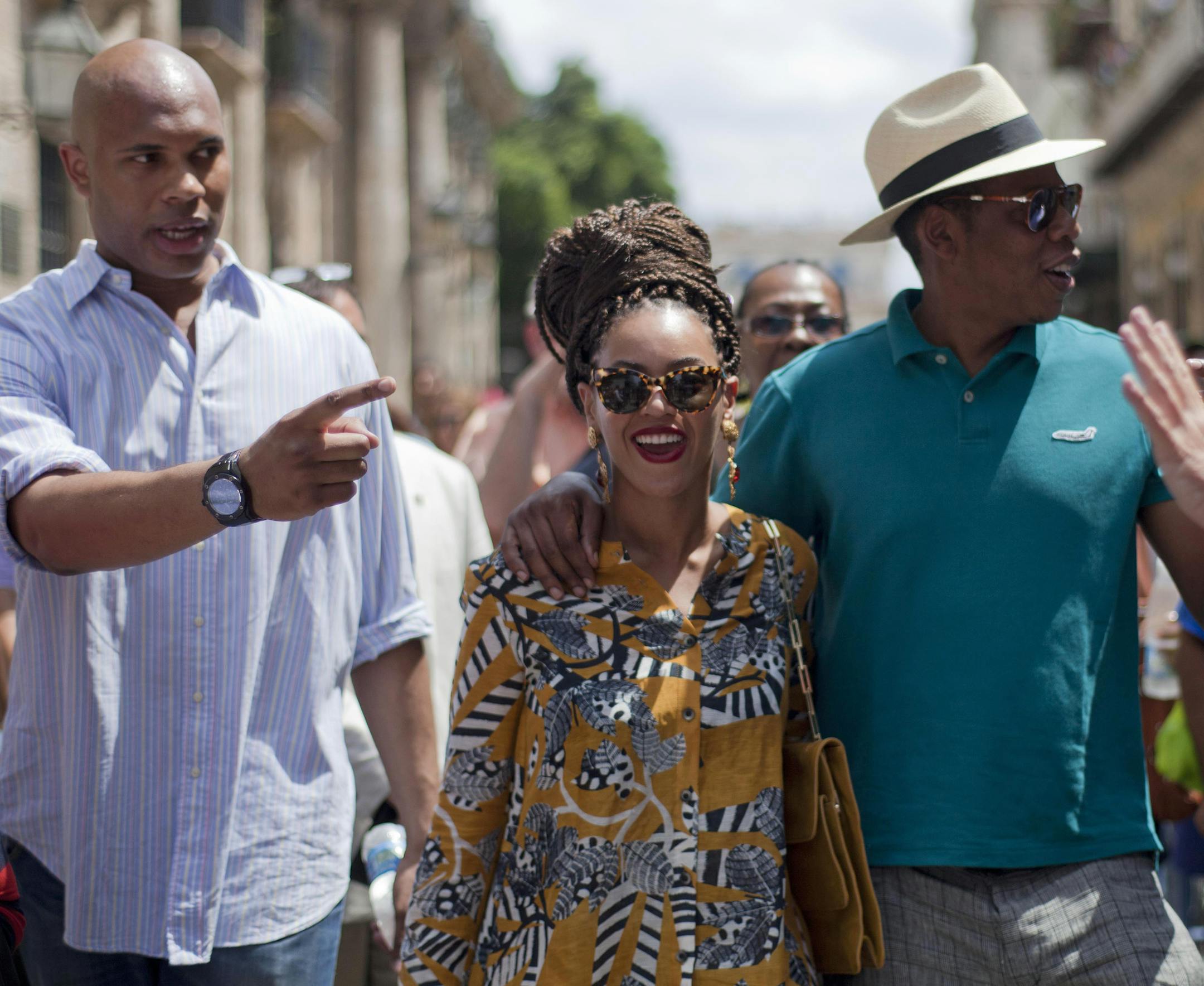 U.S. singer Beyonce and her husband, rapper Jay-Z, right, tours Old Havana as a body guard, left, and tour guide, right, accompany them in Cuba, Thursday, April 4, 2013. R&B's power couple is in Havana on their fifth wedding anniversary. (AP Photo/Ramon Espinosa)