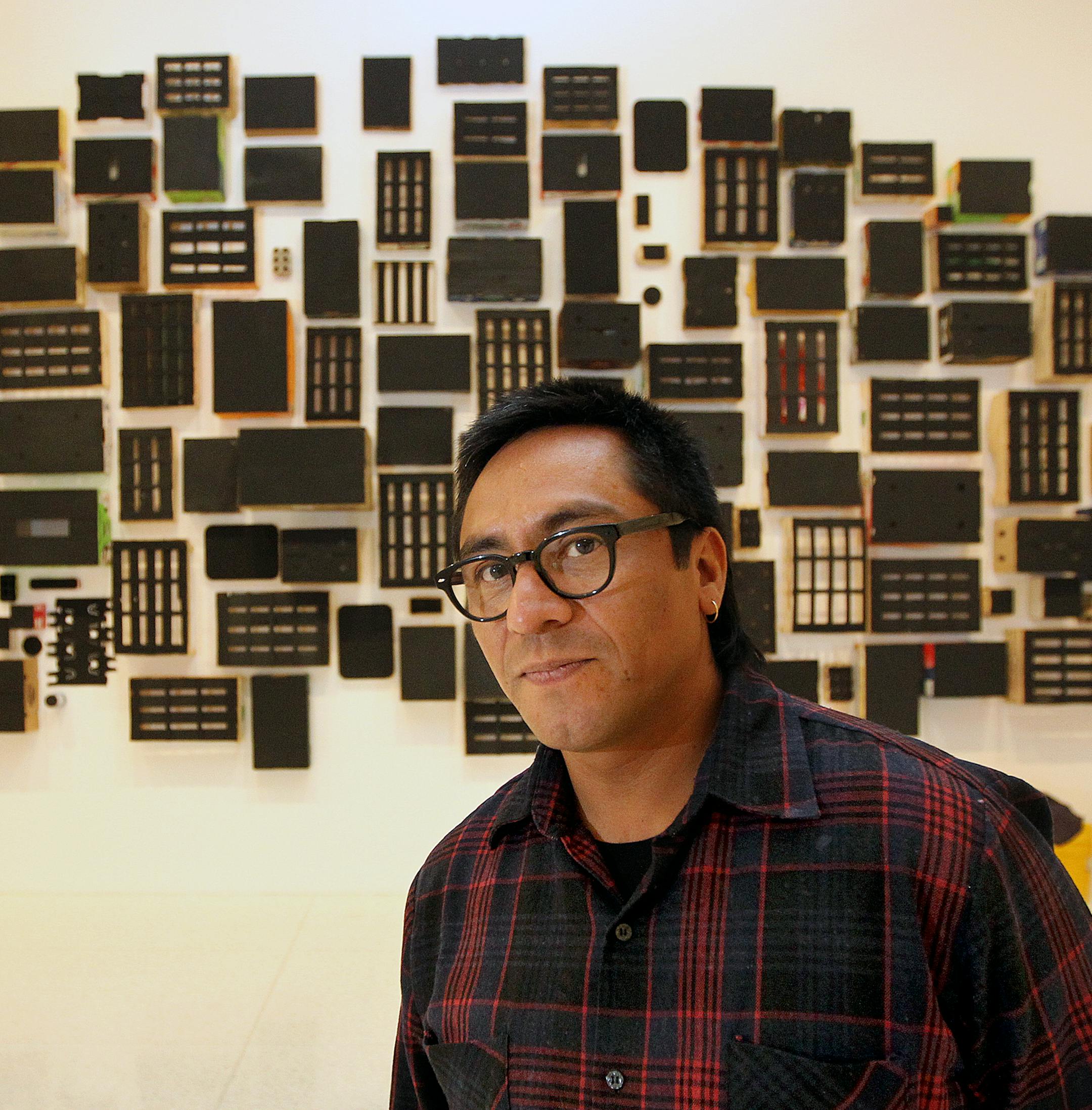 Mexico City-based artist Abraham Cruzvillegas at his installation at the Walker Art Center. Sculptures and installations by Mexico City-based artist Abraham Cruzvillegas are featured at Walker Art Center in the artist's first mid-career exhibit. [ STAR TRIBUNE/TOM WALLACE Assignments #20028144A March 22, 2013 SLUG 72130 abbe032913 EXTRA INFORMATION Mary Abbe reporter. Artist and curator at the gallery.