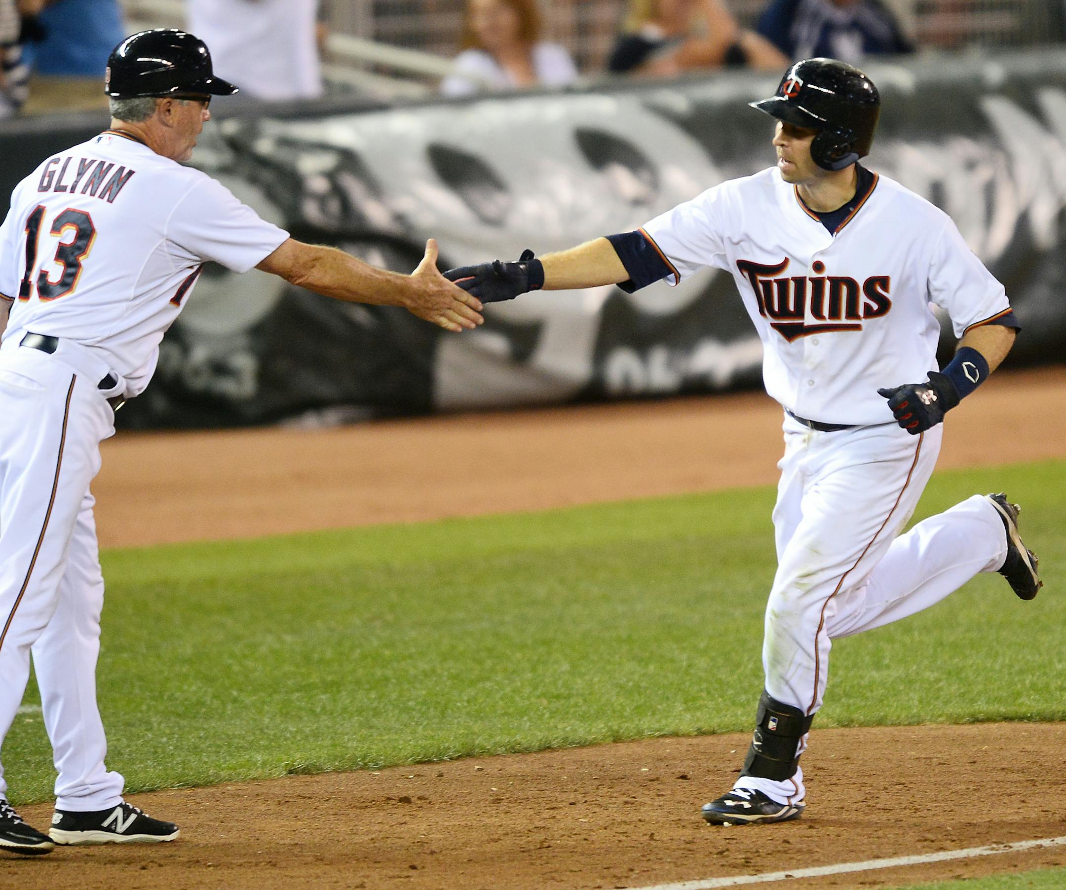 Minnesota Twins third base coach Gene Glynn (13) high fives second baseman Brian Dozier after Dozier's 2-run homer in the bottom of the eighth inning against the Yankees. ] Aaron Lavinsky • aaron.lavinsky@startribune.com The Minnesota Twins played the New York Yankees Friday, July 24, 2015 at Target Center in Minneapolis, Minn.