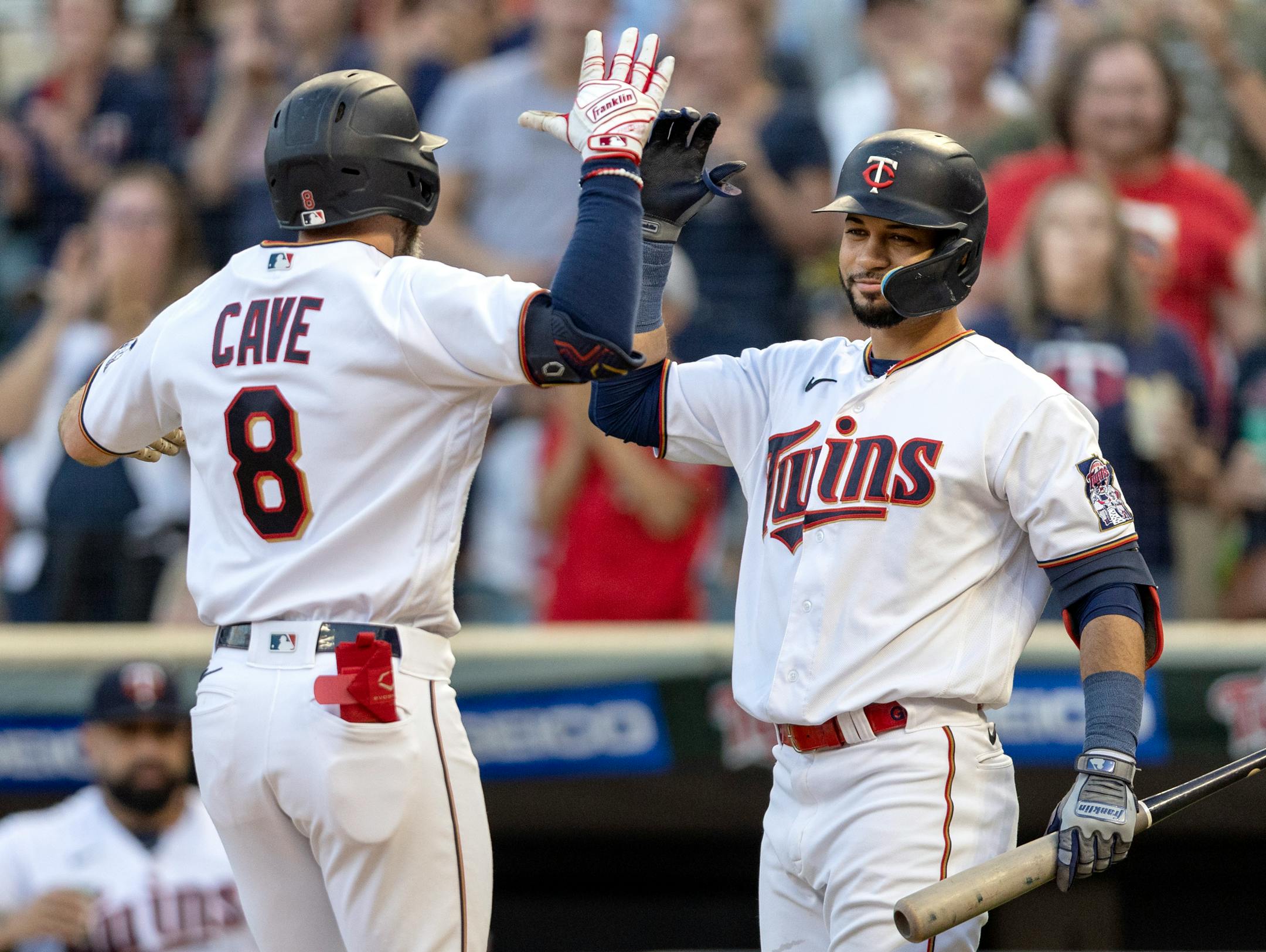 Jake Cave (5) celebrates with Gilberto Celestino of the Minnesota Twins after hitting a home run in the second inning.