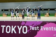 Winning athletes pose after the finals of the 10m Air Rifle Mixed Team competition during the Tokyo 2020 Olympic Game Shooting test event Tuesday, May