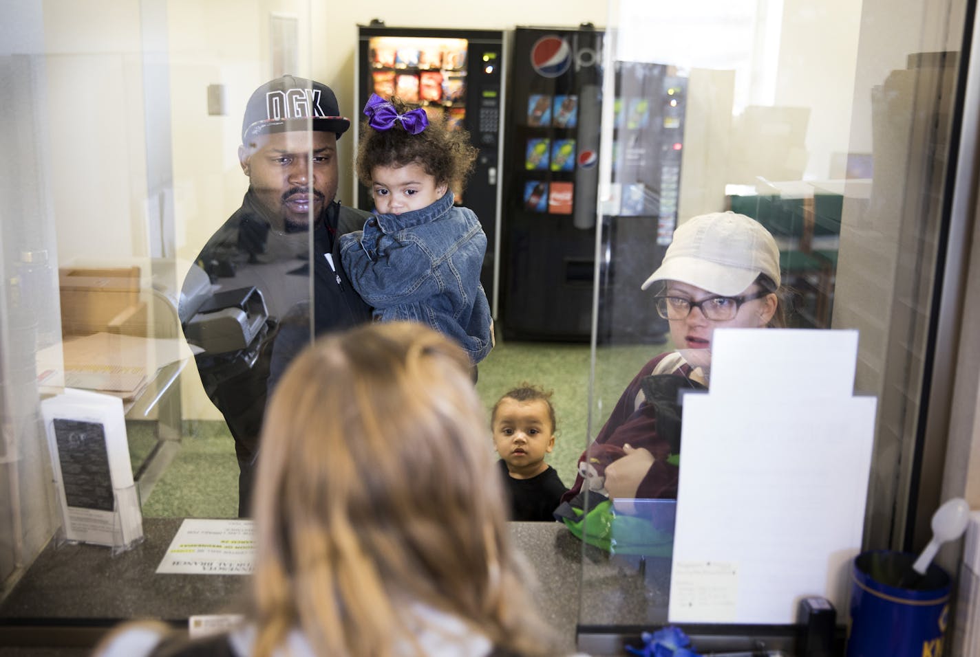 Rashaad Wren, left, his wife Alicia, right, and their children Bailee, 1, and Samson, 3, seek help on custody questions concerning Alicia's other children at the Legal Self-Help Center. ] LEILA NAVIDI &#xef; leila.navidi@startribune.com BACKGROUND INFORMATION: The Legal Self-Help Center located at the Anoka County Courthouse in Anoka on Tuesday, March 28, 2017. A look at a new but growing legal self-help center program in the tenth judicial district. While other counties run similar centers, off