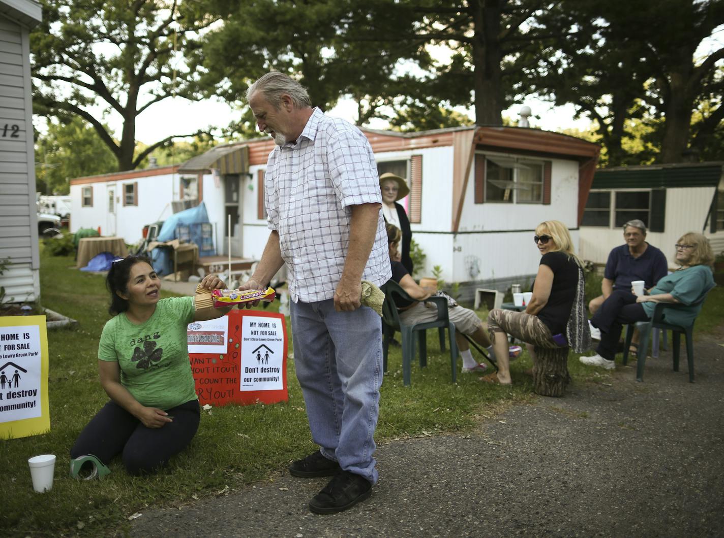 Bill McConnell offered Antonia Alvarez a cookie as residents of Lowry Grove mobile home park gathered informally Thursday evening. Alvarez led effort by tenants to buy the land their homes are on. ] JEFF WHEELER &#xef; jeff.wheeler@startribune.com Manufactured homes are often the only affordable housing in many suburbs. They also provide the only glimmer of ethnic and racial diversity, but their numbers are declining in the Twin Cities. Preserving these communities should be a priority, accordin