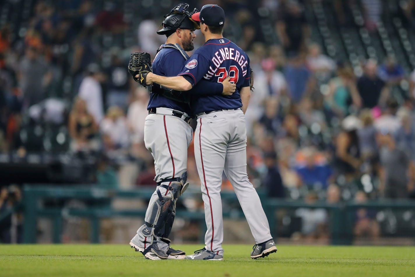 Twins relief pitcher Trevor Hildenberger is hugged by catcher Bobby Wilson after his first save of the year