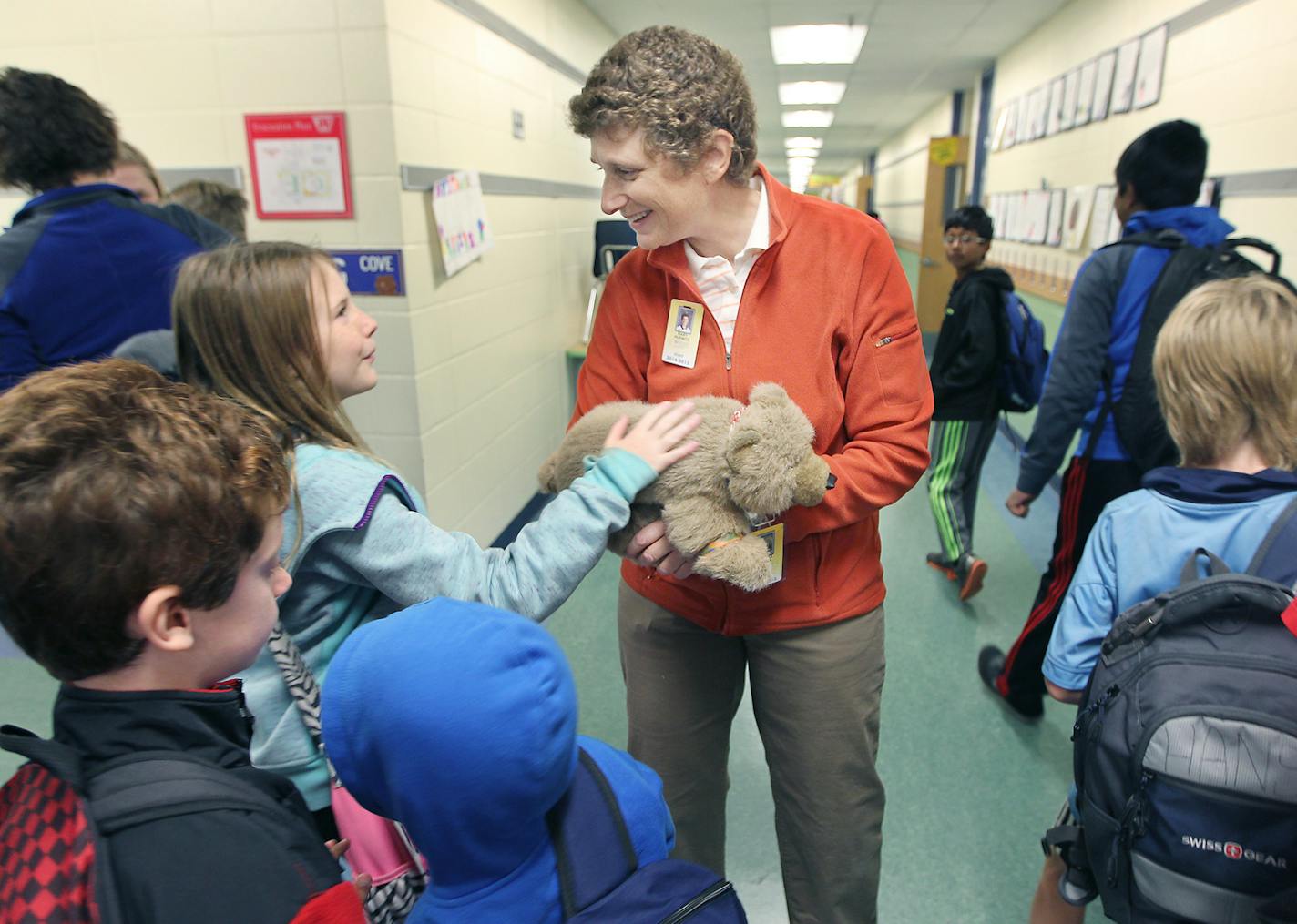 Greenwood Elementary physical education teacher Mary Hurwitz greeted students with the school&#x2019;s mascot, &#x201c;Grizzy Bear.&#x201d;