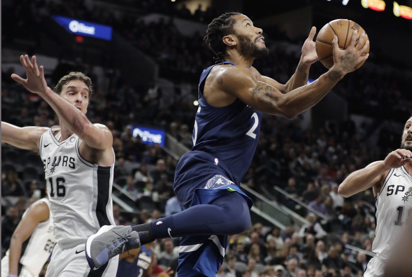 Minnesota Timberwolves guard Derrick Rose (25) drives to the basket past San Antonio Spurs center Pau Gasol (16) during the first half of an NBA basketball game, Wednesday, Oct. 17, 2018, in San Antonio. (AP Photo/Eric Gay)