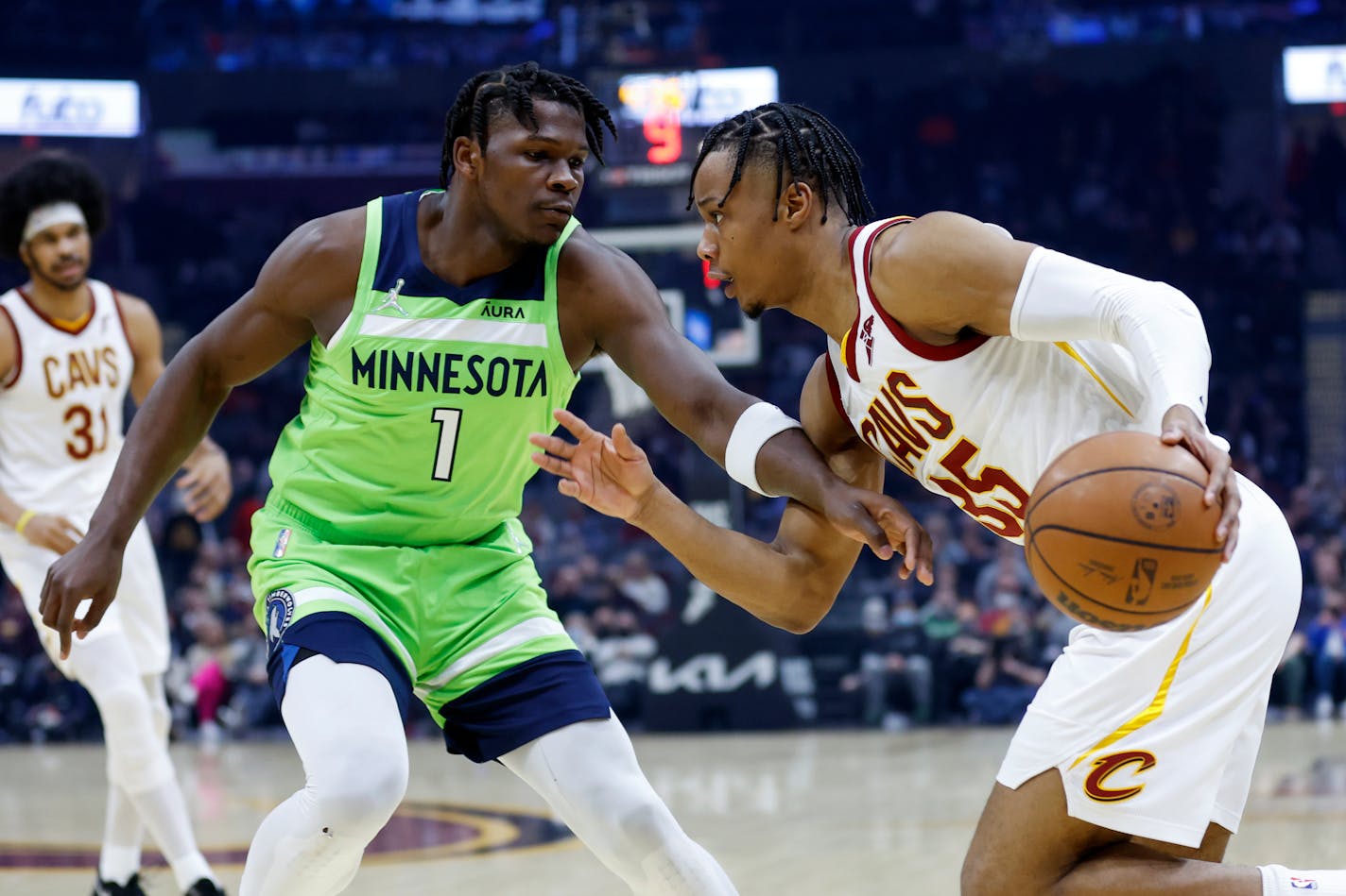 Cleveland Cavaliers' Isaac Okoro (35) drives against Minnesota Timberwolves' Anthony Edwards (1) during the first half of an NBA basketball game Monday, Feb. 28, 2022, in Cleveland. (AP Photo/Ron Schwane)