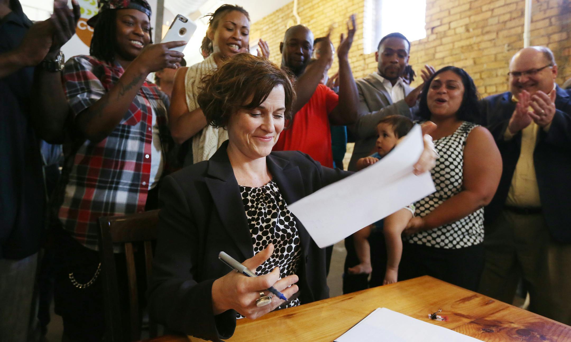 Mayor Betsy Hodges singed the landmark earned sick and safe time ordinance at the Common Roots Cafe Tuesday May 31, 2016 in Minneapolis, MN.] Jerry Holt /Jerry.Holt@Startribune.com