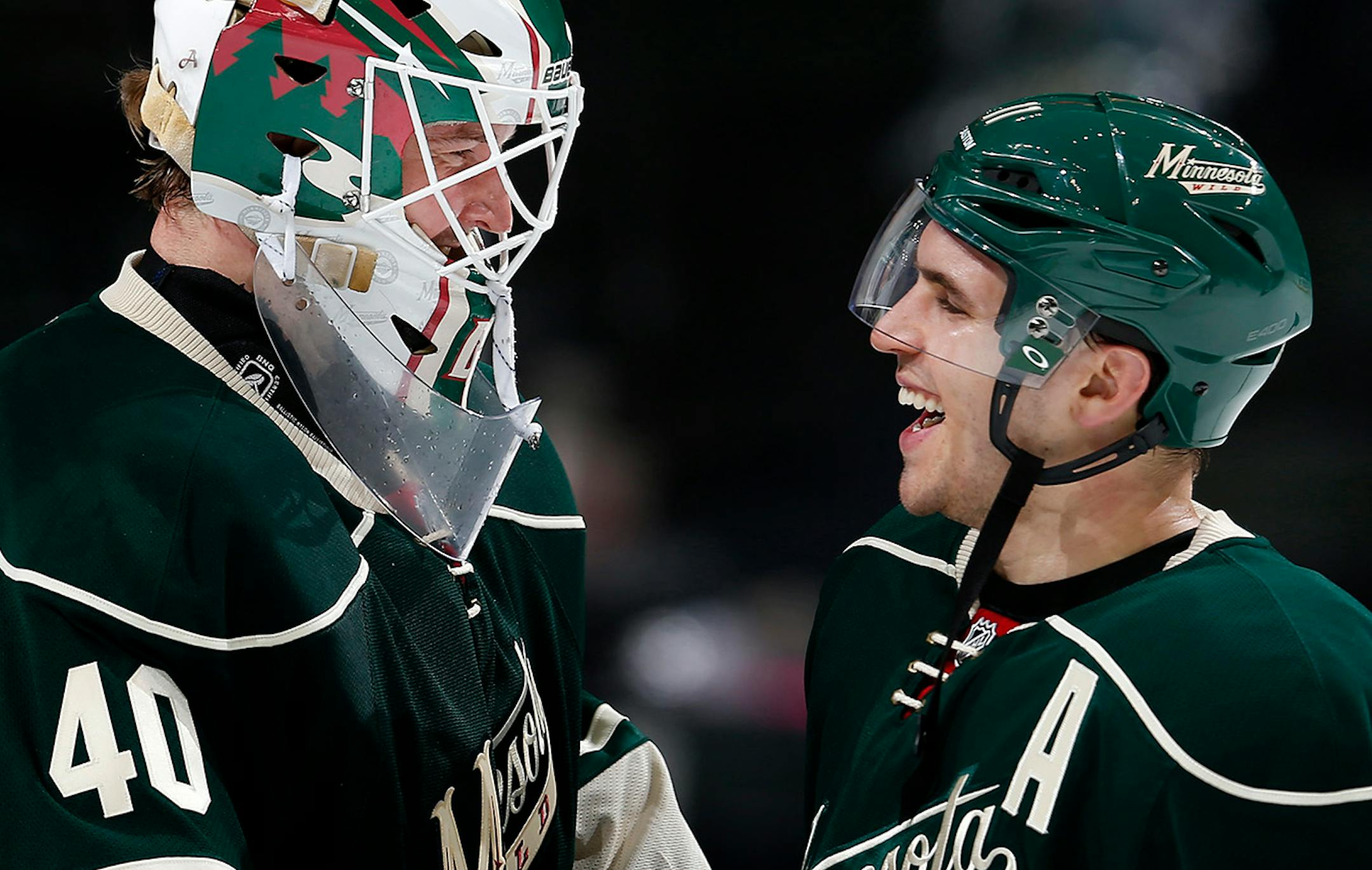 Minnesota Wild goalie Devan Dubnyk (40) and Zach Parise celebrated at the end of the game. Minnesota beat Chicago by a final score of 3-0.