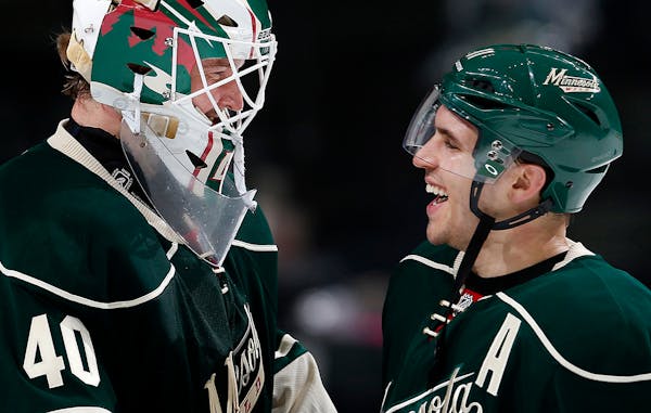Minnesota Wild goalie Devan Dubnyk (40) and Zach Parise celebrated at the end of the game. Minnesota beat Chicago by a final score of 3-0.