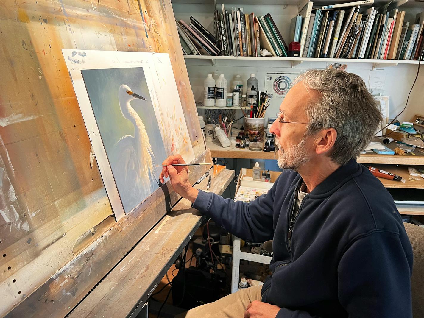 Joe Hautman, winner of the 2022 federal duck stamp conteat — his sixth such win — at work in his Twin Cities suburban home studio.