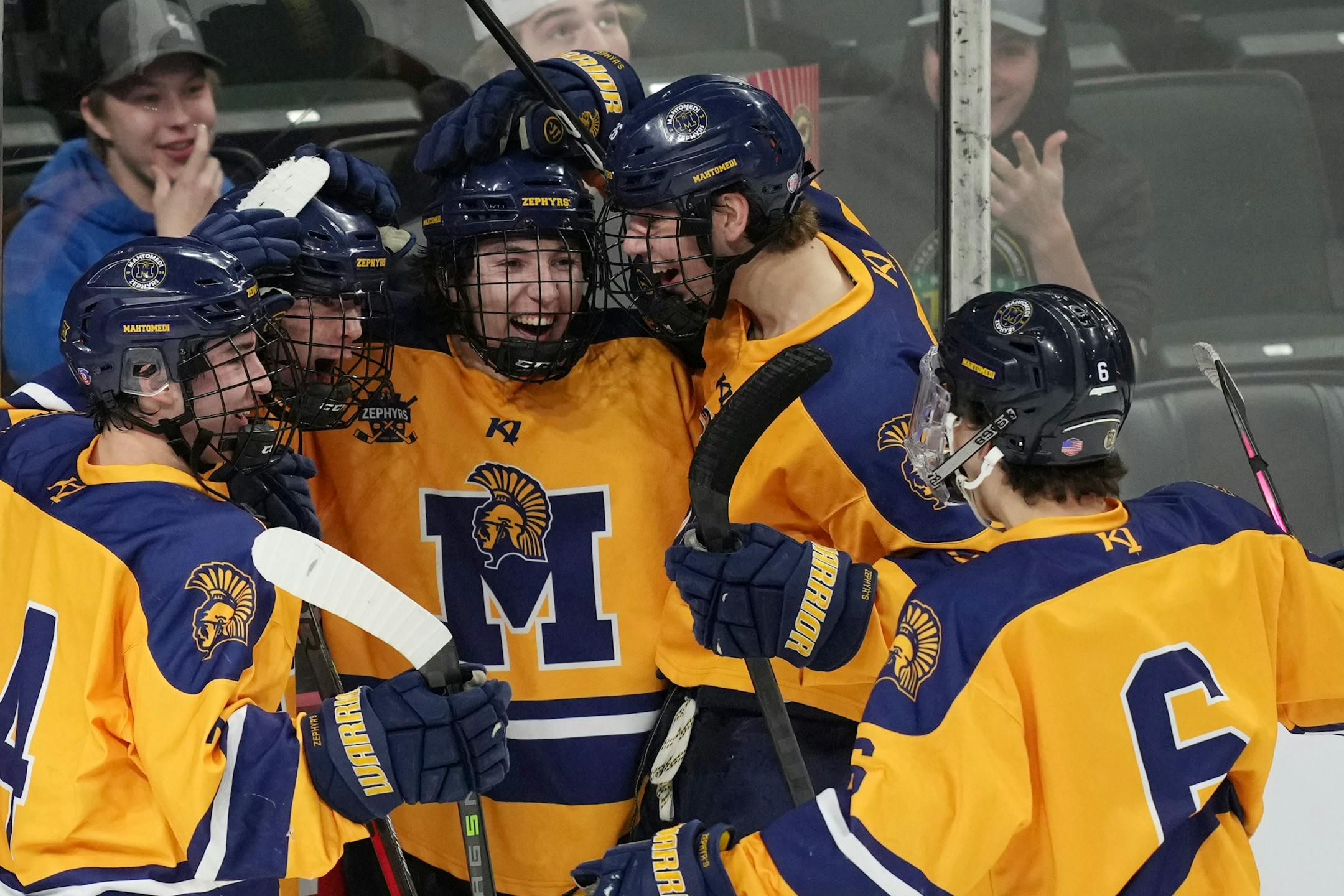 Mahtomedi forward Corey Bohmert (24) celebrates with his teammates after scoring in the third period of a MSHSL Class 1A quarterfinal hockey game between Alexandria and Mahtomedi.