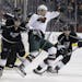 Jarret Stoll, left, collides with Minnesota Wild's Cal Clutterbuck as Kings' Justin Williams, background right, controls the puck