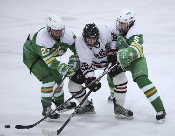 Eden Prairie's Steven Spinner was sandwiched between the defense of Edina's Tyler Nanne, left, and Parker Reno.
