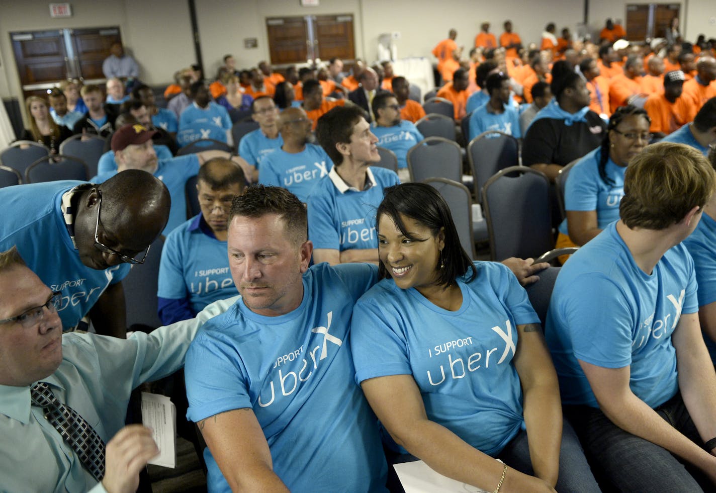 A few dozen Uber supporters came out to Wednesday night's MAC public hearing. ] (AARON LAVINSKY/STAR TRIBUNE) aaron.lavinsky@startribune.com In response to the explosion of transportation options to ferry airport passengers, such as Uber and Lyft, the Metropolitan Airports Commission is considering a big change in the way it regulates taxicabs. The change would reduce a $3,350 one-time fee to $100 now charged to cabbies to serve the airport, making it easier for more to enter the market. But at