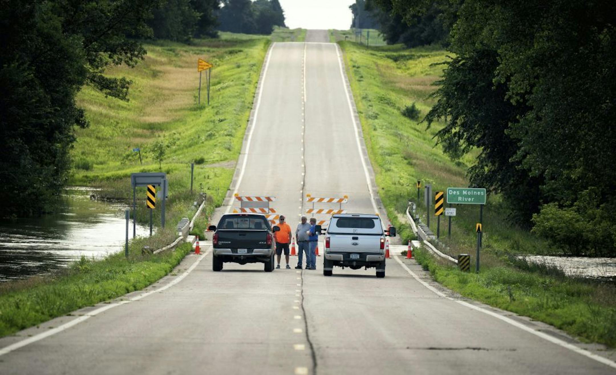 Highway 30 near Currie, Minn., is closed because of flooding from the swollen Des Moines River, Friday, July 6, 2018.