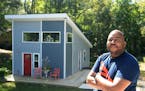 Developer Kevin Young in front of a tiny house at his tiny house development in northwest Charlotte, N.C. Neighbors iare upset about his planned devel